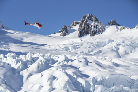 Helicopter flying to Mount Cook over snow capped mountains