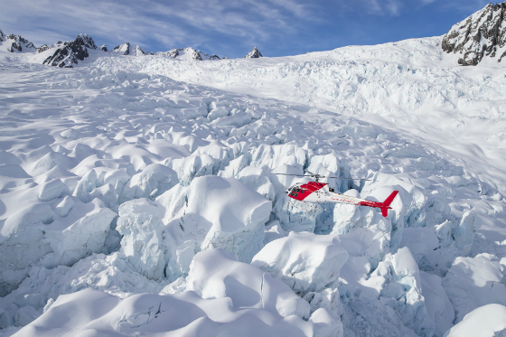 Helicopter Hovering Over Glacial Features